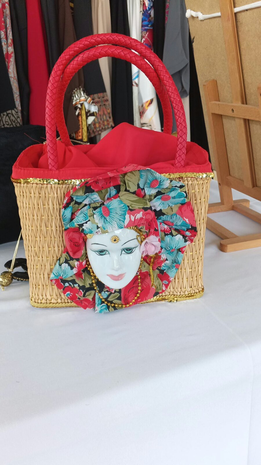 Panier en paille à anses tressées rouges, visage en porcelaine et tissu fleuri
